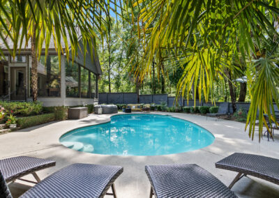 Relaxing home pool backyard photo with palm trees in Greenwood, SC