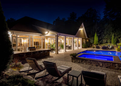Elegant backyard patio and pool real estate photo at nightfall